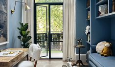 a living room with blue walls and furniture