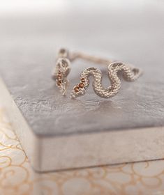 Fab and Sophisticated snake band in Bohemian Chic style. The snake texture inspired by mystical alchemical Ouroboros snake, which is one of the traditional infinity symbols. It has comfort fit and you won't want to take it off! About this item: -Flipped brown diamonds. 0.05 total carat weight -Solid 10K Rose/Yellow/White Gold OR -Solid 14K Rose/Yellow/White Gold OR -Solid 18K Rose/Yellow/White Gold PLEASE NOTICE: This price is for the ring's sizes up to 8, if you need a bigger size > contact Unique Snake-shape Wedding Ring, Elegant Handmade Snake Ring, Ouroboros Ring, Witchy Ring, Bohemian Chic Style, Snake Texture, Ouroboros Snake, Witch Rings, Brown Diamonds