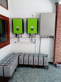 several boxes are stacked on the floor in front of an electrical panel