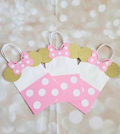 two paper bags with minnie mouse ears and polka dots on them, sitting next to each other