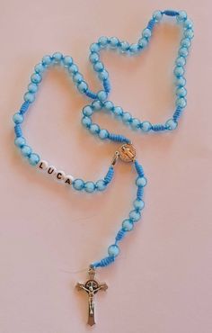 "Personalized boys rosary with blue beads. Send us a note in \"Add your personalization\" tab with the name or initials you want on rosary. As well as any other request. You can put rosary on neck and has a clasp so it will fit adults, teens and kids a like. Handwoven by our family in Medjugorje. Centerpiece and cross is Saint Benedict. Rosary lenght is 42 cm (16.5 inches) Beads size is 8 mm. Each rosary is made to order specially for you. Very light and can be worn in any occasion. Specially gr Adjustable Blue Rosary With Miraculous Medal, Adjustable Blue Rosary With 8mm Beads, Blue Rosary With Round Beads For Gift, Blue Spiritual Rosary As A Gift, First Communion Gifts For Boys, Communion Gifts For Boys, Confirmation Gifts For Boys, Our Lady Of Medjugorje, Boys First Communion