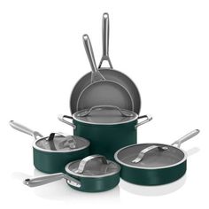 the green pots and pans are set up on top of each other with silver lids