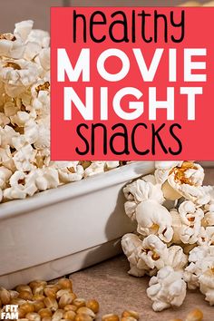 the words healthy movie night snacks are in front of a pile of popcorn kernels