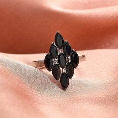 This natural gemstone ring is a beautiful piece of jewelry. This cluster ring features a collection of oval, genuine gemstones of natural Thai Black Spinel clustered together on a durable silver-color stainless steel band. The gemstones are well placed close to each other, giving a harmonious look. This ring is inspired by a cluster theme that symbolizes unity and togetherness, as each gemstone is brought together to create a beautiful and cohesive piece of jewelry. The stainless steel band provides a sturdy base for the gemstones and is resistant to rust and tarnish. This stainless steel ring for women is an excellent choice for anyone who wants stylish and durable jewelry with natural gemstones. This ring has a smooth under gallery that slides the finger easily. The hypoallergenic metal Silver Gift Wrap, Natural Gemstone Ring, Black Spinel, Silver Gifts, Multi Stone Ring, Stainless Steel Band, Stainless Steel Rings, Steel Ring, Cluster Ring