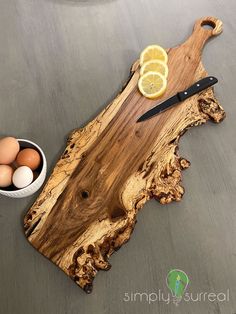 a wooden cutting board with an egg and knife on it