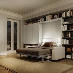 a bed sitting on top of a wooden floor next to a book shelf