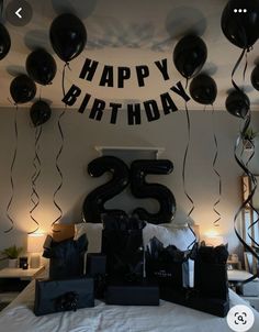 a birthday party with black balloons and white sheets on the bed is ready for someone to celebrate