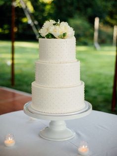 a white wedding cake sitting on top of a table