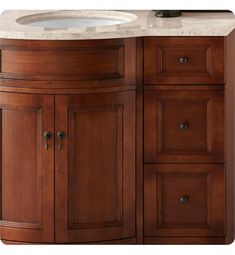 a bathroom vanity with marble counter top and wooden cabinet doors on both sides, along with an oval sink