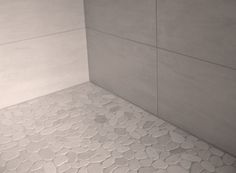 a bathroom with a white tiled floor and walls