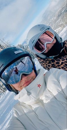 two people wearing ski goggles and snowboarding gear