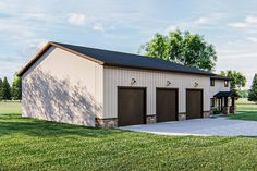 a two car garage sitting on top of a lush green field