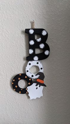 the letter b is made out of paper and decorated with black, white and orange polka dots