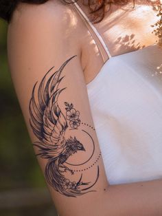 a woman with a bird tattoo on her arm