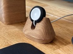 a wooden object with a light on it sitting on a table next to a mouse