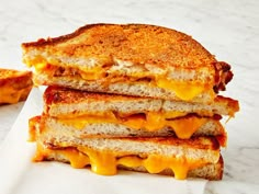 three grilled cheese sandwiches stacked on top of each other