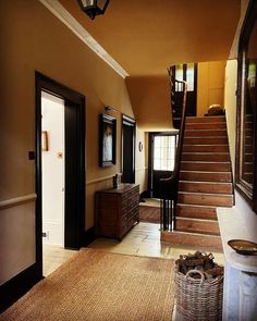 an entry way with stairs leading up to the second floor and another room on the other side