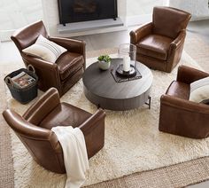 a living room with brown leather chairs and a white rug