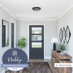 a modern entryway with wood flooring and black doors