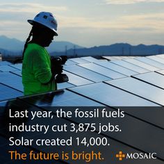 a man in green shirt and hard hat working on solar panels