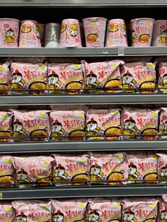 many packages of food are on display in a store shelf with hello kitty stickers