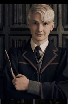 a man in a harry potter costume holding a wand