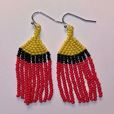 These beaded earrings will bring a pop or color to any outfit. They are hand woven with three colors throughout. Due to the light weight, this move with your movement (without a tickle). Adjustable Multicolor Woven Beaded Earrings, Multicolor Woven Adjustable Beaded Earrings, Woven Beaded Dangle Earrings For Gifts, Adjustable Red Handwoven Earrings, Gift Handwoven Adjustable Beaded Earrings, Woven Red Jewelry For Summer, Red Woven Jewelry For Summer, Adjustable Yellow Beaded Earrings For Festivals, Multicolor Woven Beaded Dangle Earrings