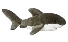 a stuffed shark is laying down on the white ground with it's mouth open