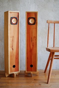 two wooden speakers sitting on top of a hard wood floor