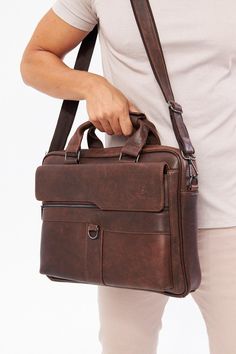 a man holding a brown leather briefcase