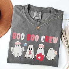 a t - shirt that says boo goo crew with ghost characters on the front and back