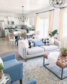 a living room filled with furniture and a chandelier