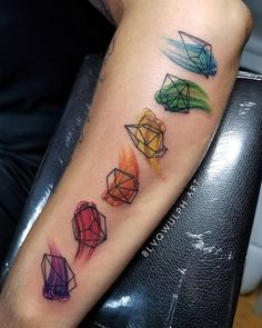 colorful tattoos on the arm of a man with an origami style tattoo design