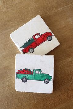 two coasters with christmas trees on them sitting on a wooden table next to each other