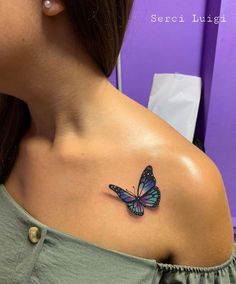 a woman with a butterfly tattoo on her shoulder