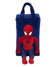 a spiderman stuffed animal sitting in front of a blue bag