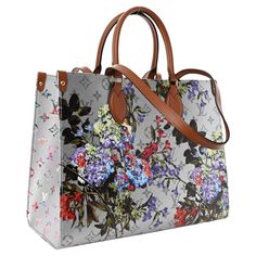 Featuring a feminine floral design and metallic-silver coated canvas, the OnTheGo MM tote by Nicolas Ghesquière adds a touch of elegance to any outfit. The bold pattern is complemented by a subtle Monogram motif in the background, and the microfiber lining adds a luxurious touch. This versatile carryall includes top handles and long leather shoulder straps for convenient carrying. All items have been previously used and present some signs of wear unless marked as 'unworn'. Please refer to the ma Designer Bags With Floral Print For Shopping, Elegant Floral Print Shopping Bag, Luxury Multicolor Floral Print Bags, Hermes Crocodile Bag, Boutique Louis Vuitton, Onthego Mm, Brown Leather Top, Prada Tote Bag, Louis Vuitton Store