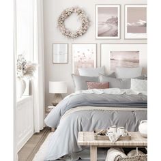 a bedroom with white walls and pictures on the wall