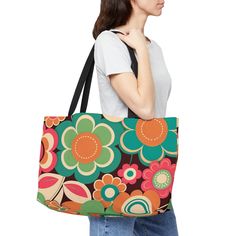 "Retro Hippie Weekender Tote Bag.  Vintage Design in groovy throwback colors and its roomy!  Groovy Retro Flower Weekender tote bag.  Throwback colors of orange, blue, green, and pink encase this sturdy vacation bag.  Great catch-all for those events when you need to bring things along.   Perfect for the hippy boho lover.  This personalized weekender bag comes in one size - 24\" x 13\" (60.9 cm x 33 cm) - perfect for those who love to travel light. Its t-bottom construction and black handles give it a sleek, classic look. Design is on 100% spun polyester in vibrant colors. .: 100% Spun Polyester .: One size: 24\" x 13\" (60.9 cm x 33 cm) .: Black interior lining .: T-bottom construction .: All-over print .: Assembled in the USA from globally sourced parts Visit our shop for more bags and a Green Retro Shoulder Bag For Shopping, Retro Green Bags, Retro Green Everyday Bag, Green Retro Everyday Bag, Retro Green Shopping Bag, Retro Green Shoulder Bag With Large Capacity, Retro Multicolor Shoulder Bag, Retro Green Tote Bag, Retro Green Tote Shoulder Bag