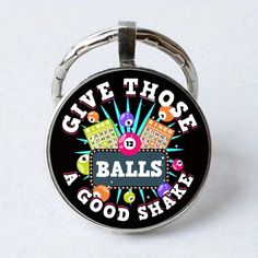 a round keychain with the words give those balls a good shake on it