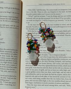 an open book with flowers in the shape of baby's booties on it