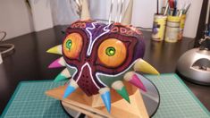 a colorful mask sitting on top of a table