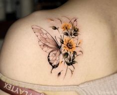 a woman's back with flowers and a butterfly on it