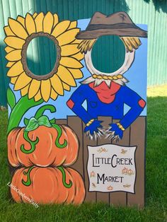 a little creek market sign with sunflowers and scarecrow