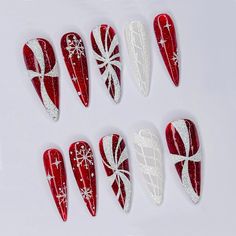 🍭 Add Festive Sparkle with Candy Cane Christmas Press-On Nails! 🍭 Celebrate the holiday season in style with this stunning red and white candy cane press-on nail set! Each nail is intricately designed with festive patterns, including sparkling snowflakes, candy cane stripes, and glittering details that capture the magic of Christmas. These long stiletto nails add a bold, eye-catching look that's perfect for any holiday event, whether it's a family gathering, a Christmas party, or a cozy night Holiday Nails Red And White, Candy Cain Nail, Red And White Candy Cane Nails, Christmas Nails Designs Red, Christmas Ornaments Nails, Candy Cane Swirl Nails, Nail Christmas Designs Xmas, Candy Cane Stripe Nails, Halloween Christmas Nails