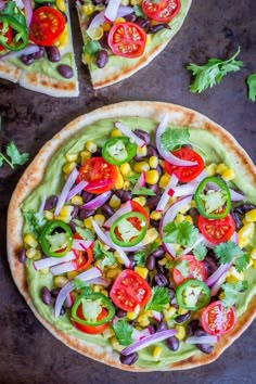 two flatbread pizzas topped with vegetables and avocado