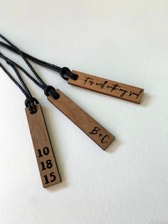 three wooden tags that say happy birthday and have numbers engraved on the strings attached to them