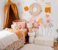 a bedroom with flowers on the wall and a bed in front of a mirror above it