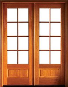 an open wooden door with glass panels