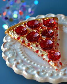 a slice of pizza with red and gold toppings on a white plate in front of a blue background